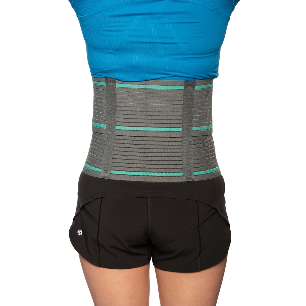 Woman showcasing back side of  an abdominal belt